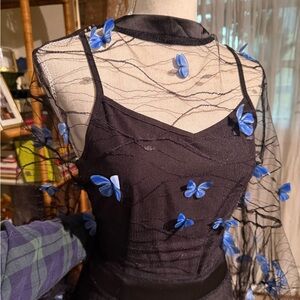 Black slipped dress with sheer overlay and blue butterflies